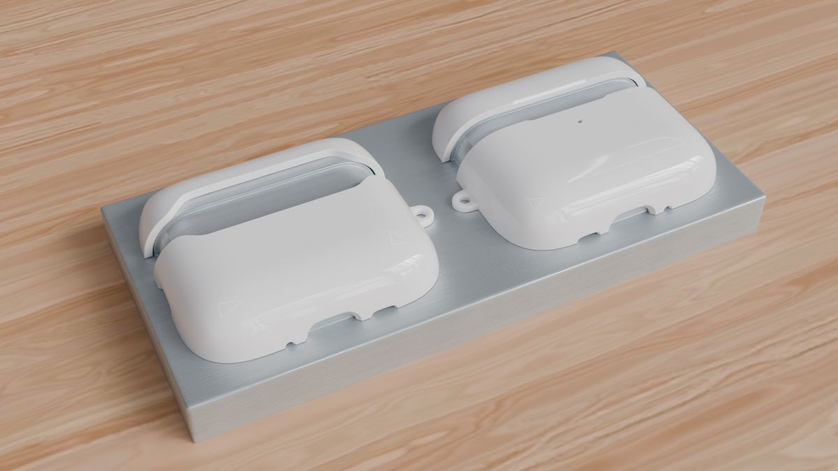 Both halves of an AirPods case mounted on the printer